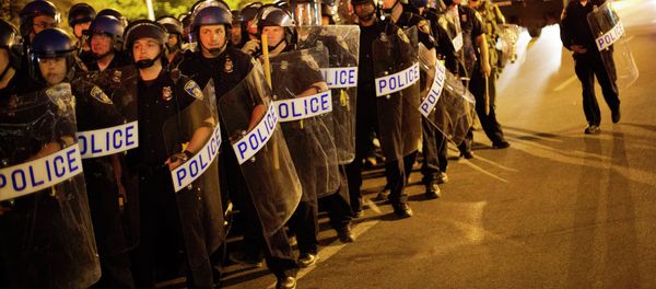 Police in riot gear line up near the scene of Monday's riots ahead of a 10 p.m. curfew Wednesday, April 29, 2015, in Baltimore. The curfew was imposed after unrest in Baltimore over the death of Freddie Gray while in police custody. Police in riot gear line up near the scene of Monday's riots ahead of a 10 p.m. curfew Wednesday, April 29, 2015, in Baltimore. The curfew was imposed after unrest in Baltimore over the death of Freddie Gray while in police custody. - Sputnik International