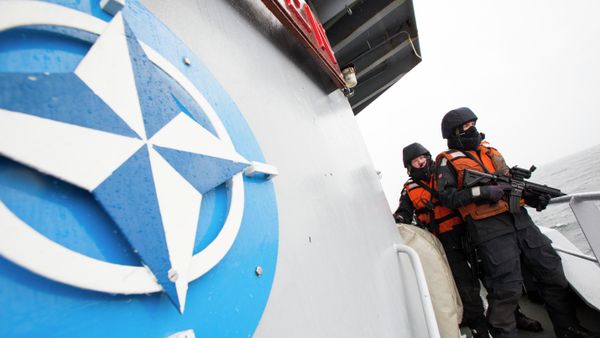 Norwegian sailors onboard the Norwegian support vessel Valkyrien pose for photographers next to the NATO logo. File photo. - Sputnik International
