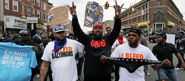 A man who calls himself Goldie Loc, center left, walks with a man who calls himself Wolfe, center, right, celebrating on Friday, May 1, 2015. - Sputnik International