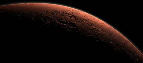 This computer-generated view depicts part of Mars at the boundary between darkness and daylight, with an area including Gale Crater beginning to catch morning light, in this handout image provided by NASA - Sputnik International