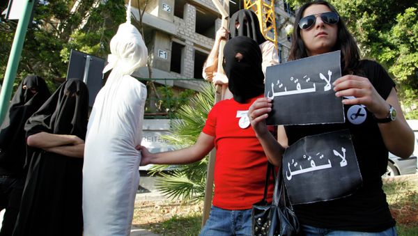 In this 2010 file photo, activists from a civil organization reenact an execution scene in front of the Saudi Arabia Embassy in Beirut, Lebanon, as they protest the beheading of a Lebanese man accused of witchcraft in Saudi Arabia. - Sputnik International