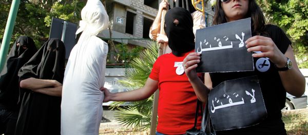In this 2010 file photo, activists from a civil organization reenact an execution scene in front of the Saudi Arabia Embassy in Beirut, Lebanon, as they protest the beheading of a Lebanese man accused of witchcraft in Saudi Arabia. - Sputnik International