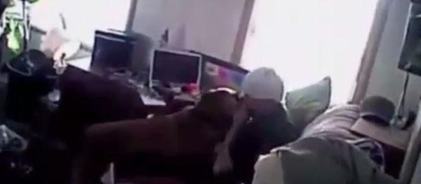 Police body-cam footage released as part of a lawsuit shows officers from the West Jordan Police Department in Utah siccing their dog on a man as he sits on his sofa with his hands raised. - Sputnik International