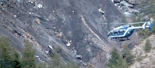 A rope hangs from a rescue helicopter flying past debris of the Germanwings passenger jet, scattered on the mountainside, near Seyne les Alpes, French Alps A rope hangs from a rescue helicopter flying past debris of the Germanwings passenger jet, scattered on the mountainside, near Seyne les Alpes, French Alps - Sputnik International