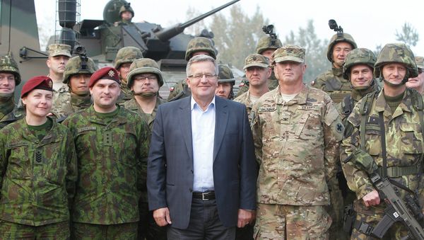 Poland’s President Bronislaw Komorowski stands with troops from Poland and other nations in Bemowo Piskie near Orzysz, in northeastern Poland - Sputnik International