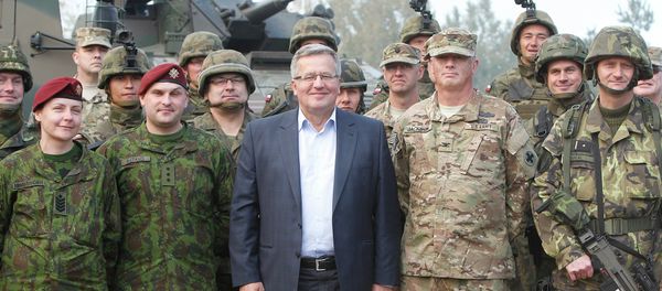 Poland’s President Bronislaw Komorowski stands with troops from Poland and other nations in Bemowo Piskie near Orzysz, in northeastern Poland - Sputnik International