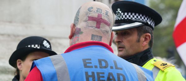 A supporter of the far-right English Defence League (EDL) speaks with police during a march in London on September 20, 2014 A supporter of the far-right English Defence League (EDL) speaks with police during a march in London on September 20, 2014 - Sputnik International