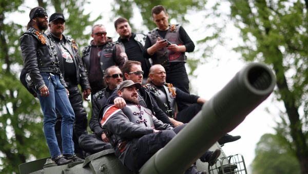 Members of the motorcycle group called Night Wolves coming from Russia, Macedonia and Bulgaria pose for a picture on top of a Red Army tank at the German-Russian museum Berlin-Karlshorst in Berlin, Germany, May 8, 2015 - Sputnik International