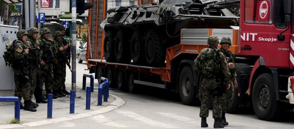 A truck loaded with a damaged armored police vehicle passes near police check point in Kumanovo, Macedonia A truck loaded with a damaged armored police vehicle passes near police check point in Kumanovo, Macedonia - Sputnik International