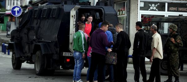 People are evacuated with an armored vehicle near a police checkpoint in Kumanovo, Macedonia, May 9, 2015 People are evacuated with an armored vehicle near a police checkpoint in Kumanovo, Macedonia, May 9, 2015 - Sputnik International