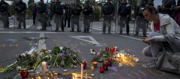 A woman lights a candle to commemorate policemen who were killed in a gun battle, during a memorial in Skopje, Macedonia, May 11, 2015. A woman lights a candle to commemorate policemen who were killed in a gun battle, during a memorial in Skopje, Macedonia, May 11, 2015. - Sputnik International