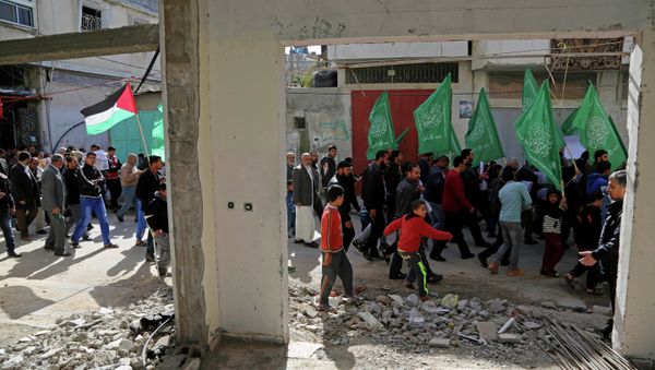 Palestinian Hamas supporters march with green Hamas and national flags in Beit Hanoun, northern Gaza Strip. Palestinian Hamas supporters march with green Hamas and national flags in Beit Hanoun, northern Gaza Strip. - Sputnik International