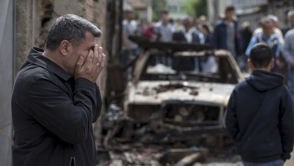 A man reacts next to a burnt out vehicle in Kumanovo, Macedonia A man reacts next to a burnt out vehicle in Kumanovo, Macedonia - Sputnik International