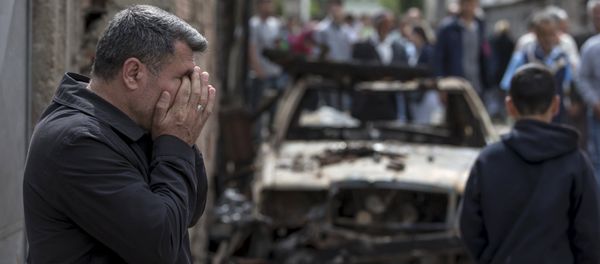 A man reacts next to a burnt out vehicle in Kumanovo, Macedonia A man reacts next to a burnt out vehicle in Kumanovo, Macedonia - Sputnik International