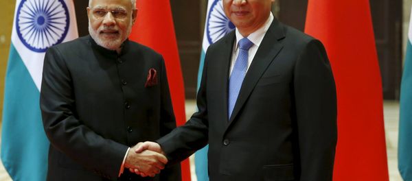 Indian Prime Minister Narendra Modi (L) and Chinese President Xi Jinping shake hands before they hold a meeting in Xian, Shaanxi province, China, May 14, 2015 - Sputnik International
