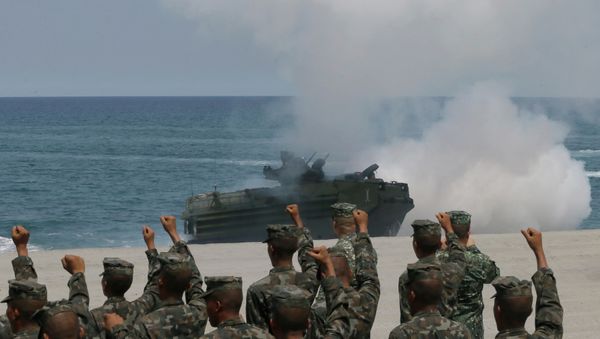 Philippine Marines cheer as a U.S. Navy AAV (Amphibious Assault Vehicle) storms the beach during a combined assault exercise near the contested reef in the South China Sea. - Sputnik International