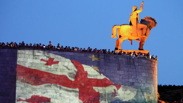 Georgian national and EU flags projected on the wall of the Metekhi Church with a monument to Vakhtang I Gorgasali, a king of Iberia, right, during a concert marking the signing of the association with EU agreement in Tbilisi, Georgia, Friday, June 27, 2014 - Sputnik International
