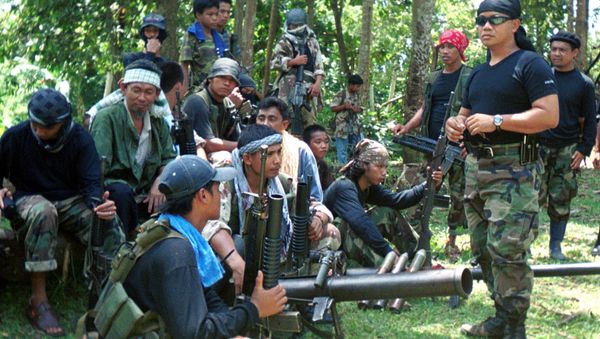 Abu Sayyaf spokesman Abu Sabaya, right foreground, is seen with his band of armed extremists in this undated photo Abu Sayyaf spokesman Abu Sabaya, right foreground, is seen with his band of armed extremists in this undated photo - Sputnik International