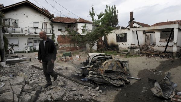 A man walks through a damaged house in Kumanovo, Macedonia May 11, 2015 A man walks through a damaged house in Kumanovo, Macedonia May 11, 2015 - Sputnik International