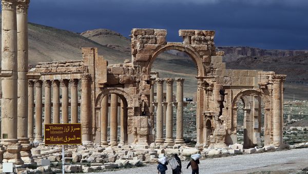 A file picture taken on March 14, 2014 shows Syrian citizens walking in the ancient oasis city of Palmyra, 215 kilometres northeast of Damascus. Islamic State (IS) group jihadists, who boast of having destroyed ancient sites in Iraq, threatened the ancient jewel of Palmyra, a UNESCO heritage site in the Syrian desert, on May 14, 2015 A file picture taken on March 14, 2014 shows Syrian citizens walking in the ancient oasis city of Palmyra, 215 kilometres northeast of Damascus. Islamic State (IS) group jihadists, who boast of having destroyed ancient sites in Iraq, threatened the ancient jewel of Palmyra, a UNESCO heritage site in the Syrian desert, on May 14, 2015 - Sputnik International