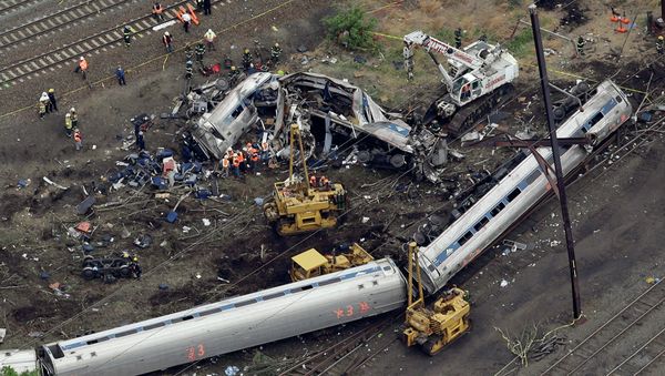 Emergency personnel work at the scene of a deadly train derailment, Wednesday, May 13, 2015, in Philadelphia - Sputnik International