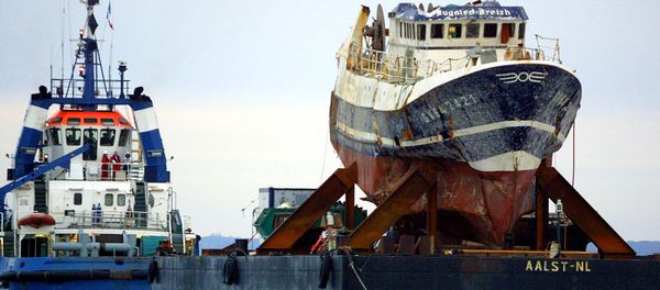 A picture taken on July 13, 2004 shows the wreckage of French trawler Bugaled Breizh, installed at a barge, as it is being towed, and escorted by military ships, towards a French military port of Brest. file photo A picture taken on July 13, 2004 shows the wreckage of French trawler Bugaled Breizh, installed at a barge, as it is being towed, and escorted by military ships, towards a French military port of Brest. file photo - Sputnik International