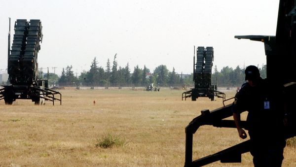 An air force radar operator inspects equipment in front of a Patriot missile launcher at Tatoi air base, near Athens - Sputnik International