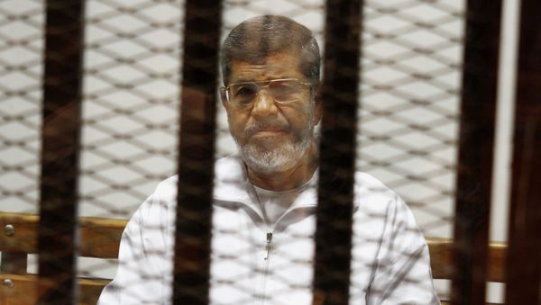 Egypt's ousted Islamist President Mohammed Morsi sits in a defendant cage in the Police Academy courthouse in Cairo, Egypt Egypt's ousted Islamist President Mohammed Morsi sits in a defendant cage in the Police Academy courthouse in Cairo, Egypt - Sputnik International