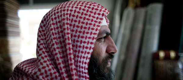 Salafi cleric Mohammed al-Shalabi, 48, widely known as Abu Sayyaf, talks during an interview with the Associated Press at a furniture store, owned by the head of Abu Sayyaf's clan, in the city of Ma'an, Jordan Salafi cleric Mohammed al-Shalabi, 48, widely known as Abu Sayyaf, talks during an interview with the Associated Press at a furniture store, owned by the head of Abu Sayyaf's clan, in the city of Ma'an, Jordan - Sputnik International