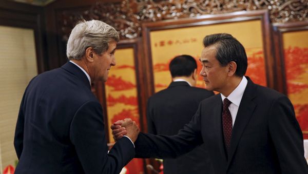 US Secretary of State John Kerry (L) shakes hands with Chinese Foreign Minister Wang Yi as he meets Chinese Premier Li Keqiang (C) at the Zhongnanhai Leadership Compound in Beijing, China, May 16, 2015 US Secretary of State John Kerry (L) shakes hands with Chinese Foreign Minister Wang Yi as he meets Chinese Premier Li Keqiang (C) at the Zhongnanhai Leadership Compound in Beijing, China, May 16, 2015 - Sputnik International