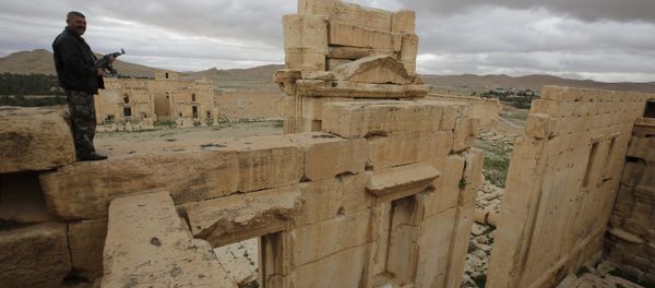 A file picture taken on March 14, 2014 shows a Syrian policeman standing on the sanctury of Baal in the ancient oasis city of Palmyra, 215 kilometres northeast of Damascus - Sputnik International
