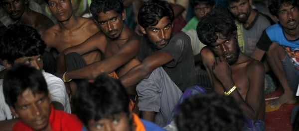 In this Sunday, May 17, 2015, file photo, Bangladeshi men listen during a visit by Bangladesh's Ambassador to Indonesia Mohammad Nazmul Quaunine at a temporary shelter in Langsa, Aceh province, Indonesia - Sputnik International