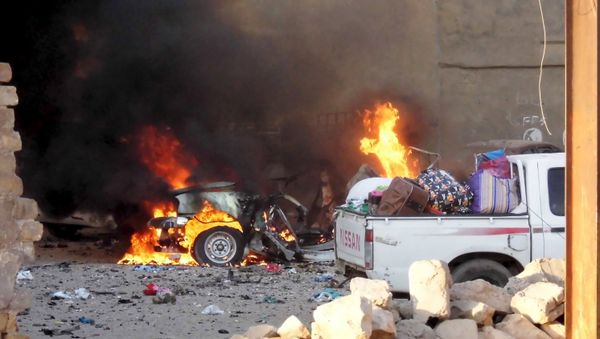 A car is engulfed by flames during clashes in the city of Ramadi, May 16, 2015 - Sputnik International