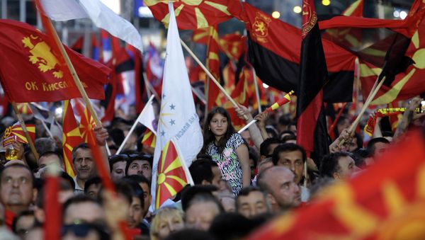 Supporters of the ruling coalition wave national and party flags, during a rally in front of the Parliament building in Skopje, Macedonia, Monday, May 18, 2015 Supporters of the ruling coalition wave national and party flags, during a rally in front of the Parliament building in Skopje, Macedonia, Monday, May 18, 2015 - Sputnik International