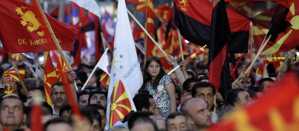 Supporters of the ruling coalition wave national and party flags, during a rally in front of the Parliament building in Skopje, Macedonia, Monday, May 18, 2015 - Sputnik International