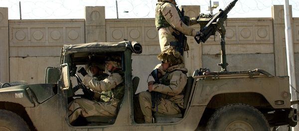 US soldiers from the 1st Battalion, 22nd Regiment of the 4th Infantry Division, ride on a military vehicle as they leave their base on a mission in Tikrit, 180 Kilometers (110 miles) north of Iraqi capital Baghdad, 30 December 2003. - Sputnik International
