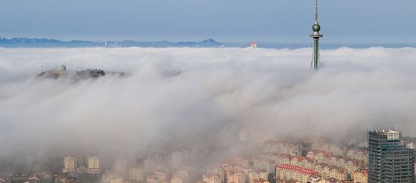 Residential buildings are seen among fog in Qingdao, Shandong province, China - Sputnik International