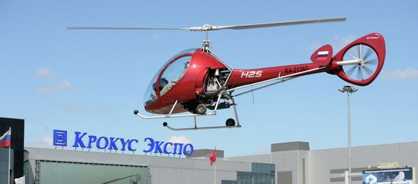 A Dynali H2S helicopter by Moscow's Crocus Expo exhibition hall before the HeliRussia 2015 expo. - Sputnik International