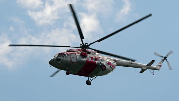 A Mi-171E (Mi-8 AMT) helicopter by Moscow's Crocus Expo exhibition hall before the HeliRussia 2015 expo. - Sputnik International