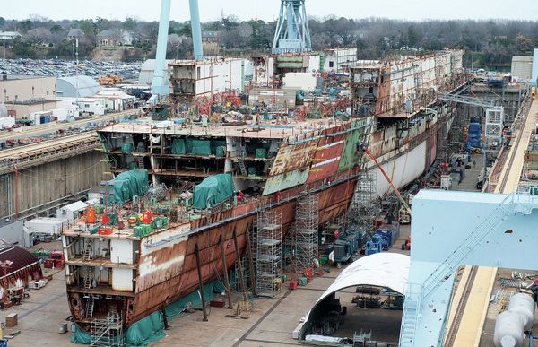 The USS Ford - seen here under construction in 2012 - ran $2 billion over budget but the Navy promised most of those costs were due to its being the first of its class and would not recur with the USS Kennedy. - Sputnik International