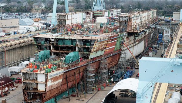 The USS Ford - seen here under construction in 2012 - ran $2 billion over budget but the Navy promised most of those costs were due to its being the first of its class and would not recur with the USS Kennedy. - Sputnik International