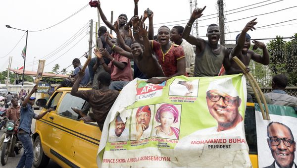 Supporters of newly-elected Nigerian President Muhammadu Buhari sit on top of a bus as they celebrate the victory their candidate in Lagos on April 1, 2015 Supporters of newly-elected Nigerian President Muhammadu Buhari sit on top of a bus as they celebrate the victory their candidate in Lagos on April 1, 2015 - Sputnik International