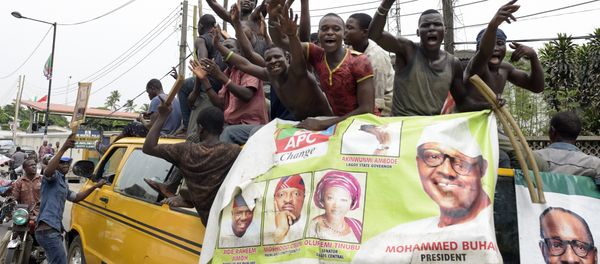 Supporters of newly-elected Nigerian President Muhammadu Buhari sit on top of a bus as they celebrate the victory their candidate in Lagos on April 1, 2015 Supporters of newly-elected Nigerian President Muhammadu Buhari sit on top of a bus as they celebrate the victory their candidate in Lagos on April 1, 2015 - Sputnik International