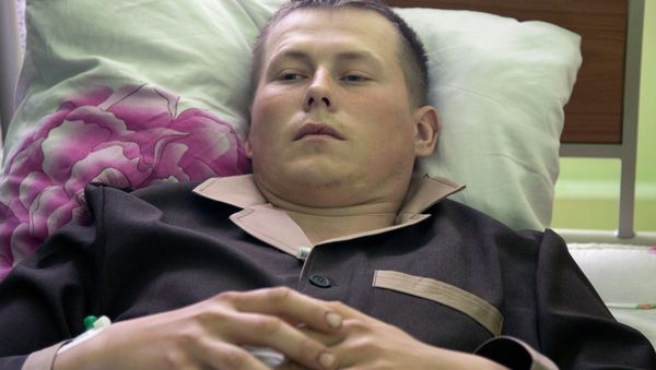 Alexander Alexandrov, who says he is a sergeant with the Russian special forces from the Volga River city of Togliatti, lies in a military hospital bed, in Kiev, Ukraine, Tuesday, May, 19, 2015 - Sputnik International