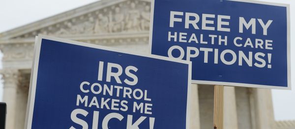 Protestors hold placards challenging Obamacare outside of the US Supreme Court on March 4, 2015 in Washington Protestors hold placards challenging Obamacare outside of the US Supreme Court on March 4, 2015 in Washington - Sputnik International