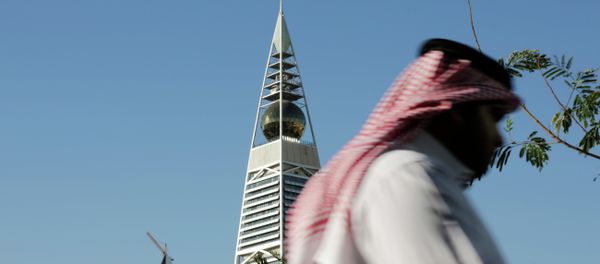 A Saudi man passes the al-Faisaliya tower in Riyadh, Saudi Arabia. A Saudi man passes the al-Faisaliya tower in Riyadh, Saudi Arabia. - Sputnik International