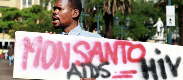 An activist carries a sign during a protest against chemical giant Monsanto in Durban on May 24, 2014 - Sputnik International