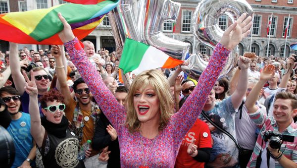 Rory O'Neill, known by the Drag persona Panti, celebrates with yes supporters at Dublin Castle, Ireland, Saturday, May 23, 2015. Ireland has voted resoundingly to legalize gay marriage in the world's first national vote on the issue, leaders on both sides of the Irish referendum declared Saturday even as official ballot counting continued. Senior figures from the no campaign, who sought to prevent Ireland's constitution from being amended to permit same-sex marriages, say the only question is how large the yes side's margin of victory will be from Friday's vote. - Sputnik International