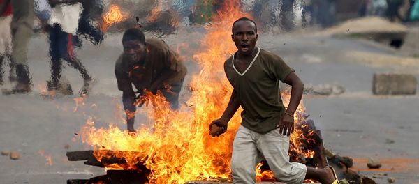 A protester runs in front of a burning barricade during a protest against Burundi President Pierre Nkurunziza and his bid for a third term in Bujumbura, Burundi, May 21, 2015 A protester runs in front of a burning barricade during a protest against Burundi President Pierre Nkurunziza and his bid for a third term in Bujumbura, Burundi, May 21, 2015 - Sputnik International