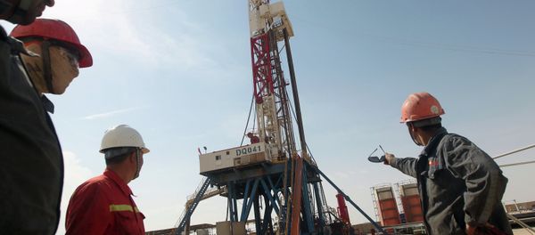 Gazprom employees look at a drilling platform for Gazprom company. File photo Gazprom employees look at a drilling platform for Gazprom company. File photo - Sputnik International